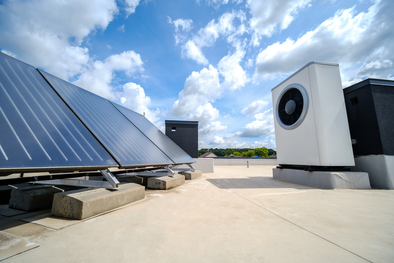 Heat pump and solar collector on the roof of the house. A system using an alternative energy source for heating water.